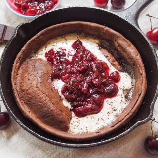 Chocolate Dutch baby pancake with cherry compote