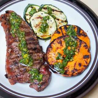 Grilled butternut squash, zucchini and steak with chimichurri sauce