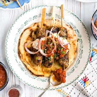Lamb giaortlou kebab - lamb kofta with tomato sauce and yoghurt