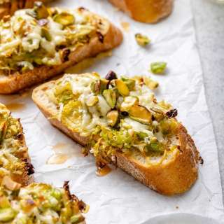 White Cheddar Brussels Sprouts & Pistachio Crostini with Hot Honey