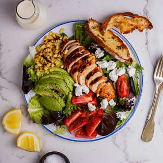 Spicy roast chicken salad with ciabatta crisps and creamy lemon dressing