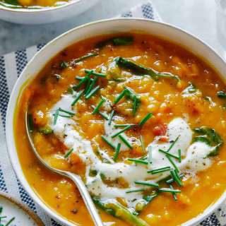 Vegan Lentil Soup with Spinach and Topped with Garlicky Almond Cream