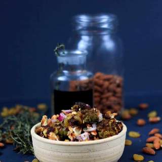 Roasted green cauliflower salad with onions, raisins and almonds