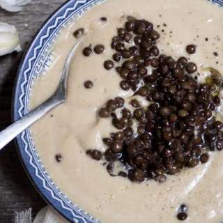 "Oysters and pearls" - celery root soup with roasted garlic and black Beluga lentils