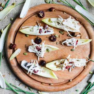 Endive spears with celery root remoulade, cranberries and pepitas