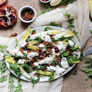Arugula salad with endive, mozzarella, pecans and pomegranate seeds