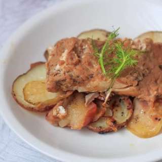 Roasted salmon on a bed of apples and potatoes
