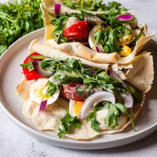 Sabich, or an eggplant sandwich with potato, eggs and pickles 