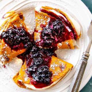 Brown Sugar Carrot Cake Crepes with Cream Cheese Filling and Blueberry Sauce