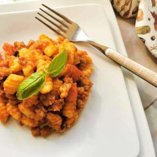 Malloreddus (Sardinian gnocchi) alla campidanese with sausage, tomato and saffron