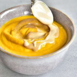 Carrot-coconut soup with peanut butter sauce