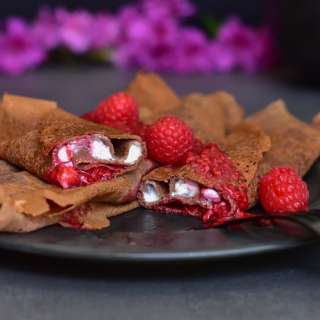 Chocolate crepes with vanilla cottage cheese and raspberry sauce