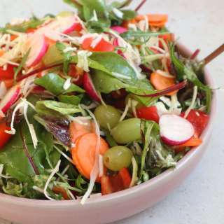 Liver Rescue salad with white cabbage, radishes, carrot, white grapes and lime dressing