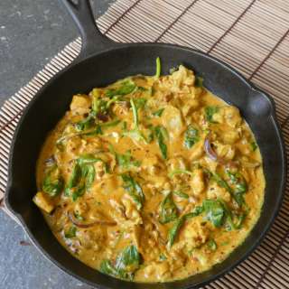 Indian chicken curry with coconut milk, spinach and turmeric