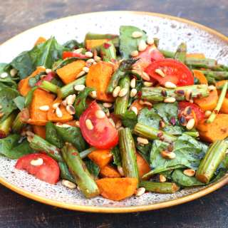 Sweet potato salad with green asparagus, spinach and pine nuts