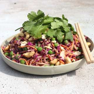 Thai salad with rice noodles, red cabbage, carrots and peas