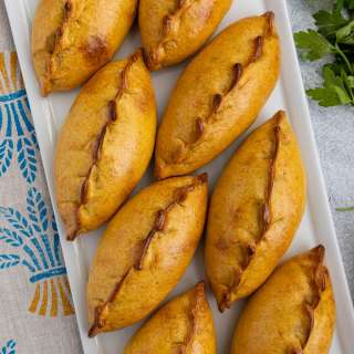 Bolivian Salteñas de Pollo (Golden Chicken, Potato, and Pea Empanadas)