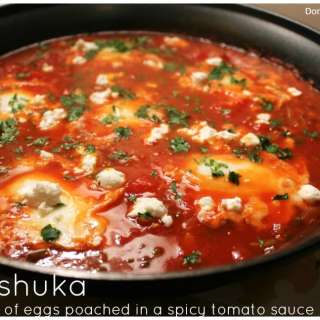 Shakshuka: Israeli dish of eggs poached in a spicy tomato sauce