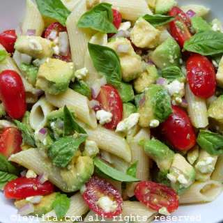Avocado pasta salad with tomatoes and feta cheese or queso fresco