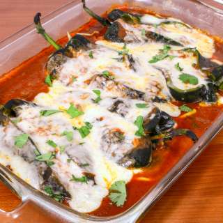 Cheesy Roasted Poblano Peppers with Homemade Refried Beans and Enchilada Sauce