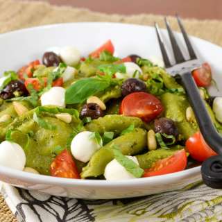 Spinach and Kale Ravioli Pasta Salad with Fresh Tomatoes, Basil, Mozzarella, and Taggiasca Olives