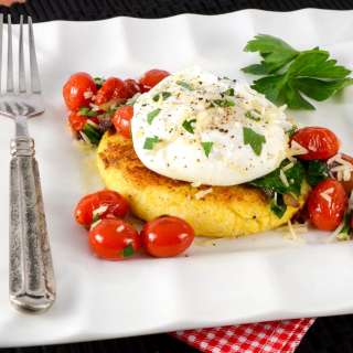 Polenta Cake Topped with Sautéed Tomatoes, Spinach, and a Poached Egg