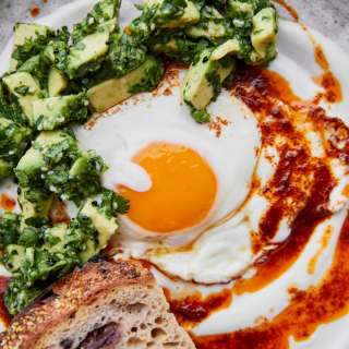 Turkish Eggs with Harissa Butter and Avocado Relish