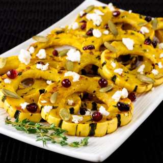 Herb Roasted Delicata Squash Topped With Pomegranate Seeds, Pepitas, and Feta