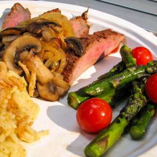 Camping Cuisine - Flank Steak with Caramelized Onions and Mushrooms alongside Asparagus and Tomatoes