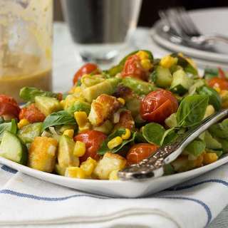 Crispy halloumi salad with roasted tomatoes, avocado and corn