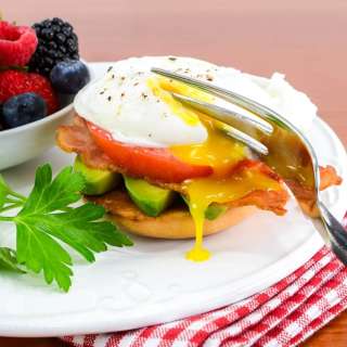 Poached Egg with Bacon, Tomato, and Avocado on a Bagel