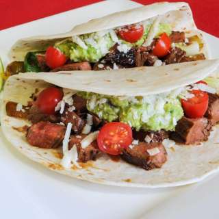 Steak, Anaheim Chile, and Scallion Tacos with Guacamole and Cotija Cheese