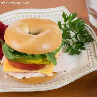 Turkey and Sharp Cheddar Bagel Sandwich with Arugula, Spinach, and Tomatoes