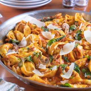 Italian Sausage Tortellini Skillet with Mushrooms and Spinach in a Creamy Tomato Sauce