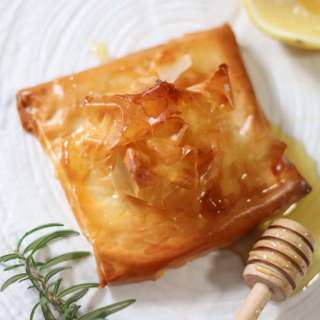 Tiropita. Baked feta wrapped in filo with honey and lemon