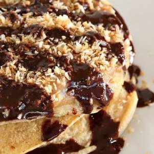 Samoa Cookie Pancakes with Salted Date Caramel, Toasted Coconut, Chocolate drizzle. Vegan Recipe