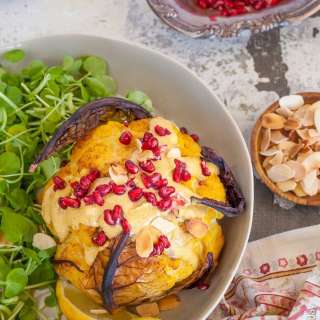 Whole roasted cauliflower head in a Tahini and Ras El Hanout Sauce