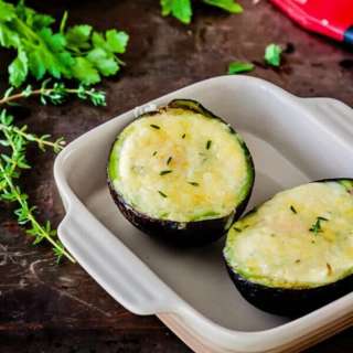 Avocado baked eggs with creme fraiche and herbs
