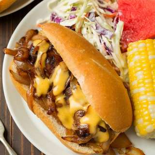 Brats with Caramelized Onions and Cheddar Cheese Sauce