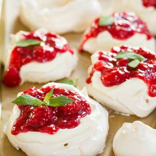 Individual Pavlovas with Cream Cheese Whipped Cream and Raspberry Sauce