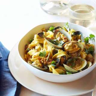 Fresh Egg Fettuccini with Manila Clams, Spicy Sausage and White Wine Saffron Reduction