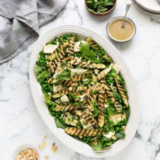 Spinach salad with grilled zucchini, peas, feta and mint
