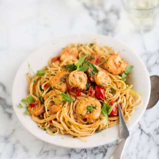 Prawn pasta with tomatoes, garlic and cream