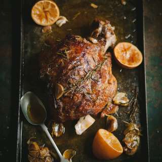 Roast shoulder of lamb with rosemary, garlic, harissa and lemon