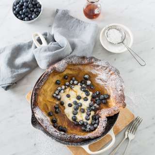 Brown butter Dutch Baby pancake with blueberries & lemon