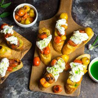 Crostini with Charred Cherry Tomatoes, Burrata and Chive Oil